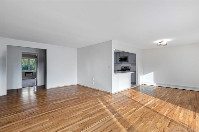 unfurnished living room with hardwood / wood-style floors