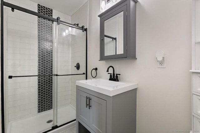 bathroom with walk in shower and vanity