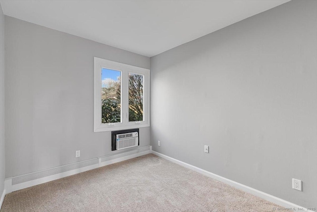 spare room with carpet flooring and an AC wall unit