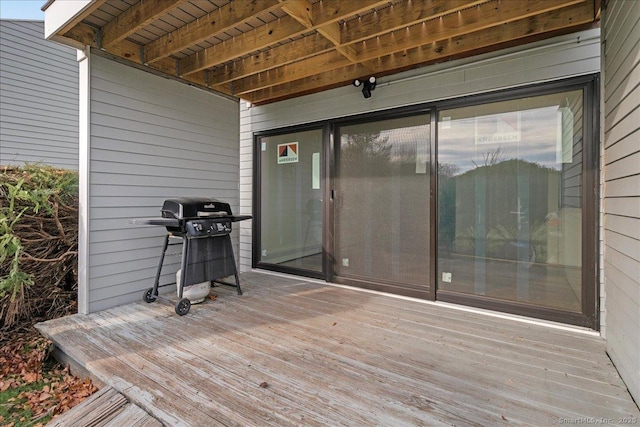 wooden terrace with a grill