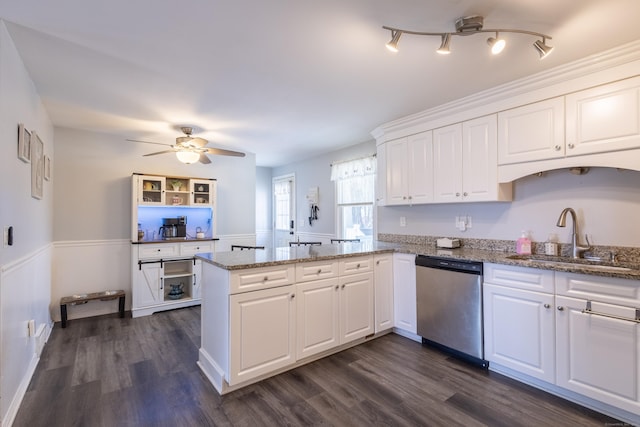 kitchen featuring sink, white cabinets, stainless steel dishwasher, and kitchen peninsula