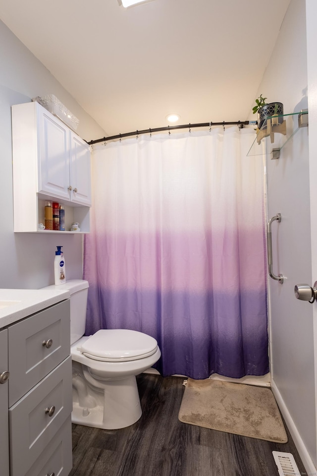 bathroom with lofted ceiling, vanity, toilet, a shower with shower curtain, and hardwood / wood-style flooring