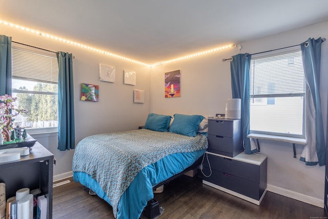 bedroom with dark hardwood / wood-style flooring