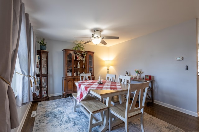 dining area featuring ceiling fan and dark hardwood / wood-style flooring