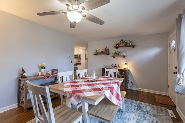 dining space with dark wood-type flooring and ceiling fan