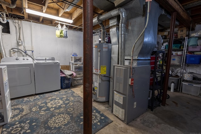 basement with heating unit, gas water heater, and independent washer and dryer