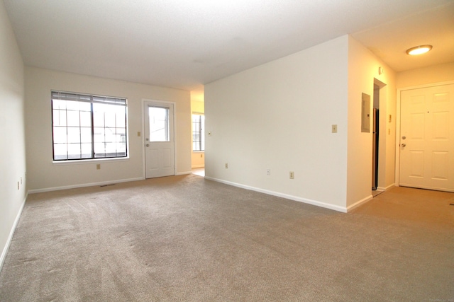 carpeted spare room with electric panel