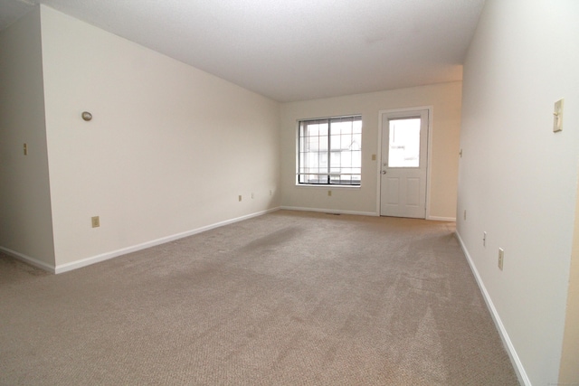 empty room featuring light colored carpet