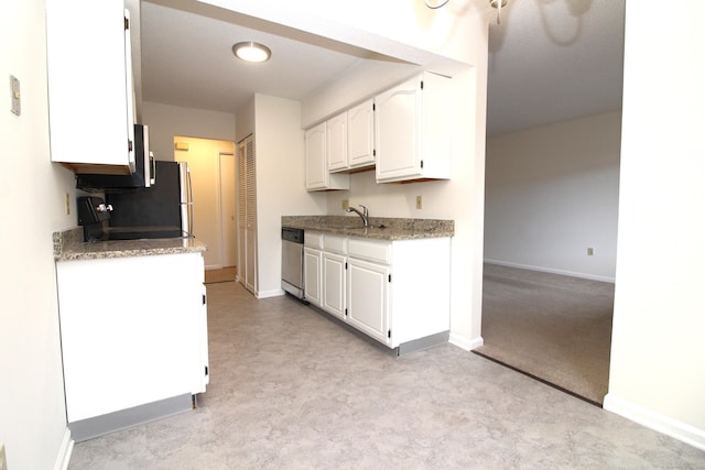 kitchen featuring sink, white cabinets, and dishwasher