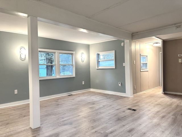 spare room featuring light hardwood / wood-style floors and plenty of natural light