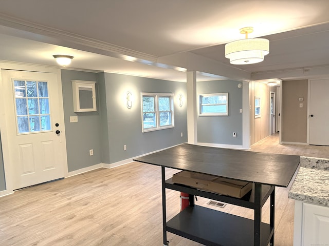 game room featuring ornamental molding and light hardwood / wood-style floors