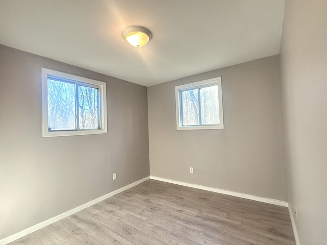 unfurnished room featuring hardwood / wood-style flooring