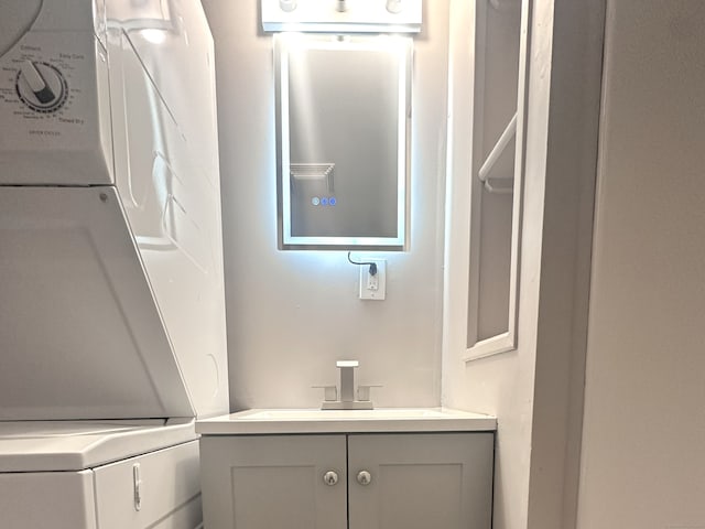 bathroom featuring vanity and stacked washer and dryer