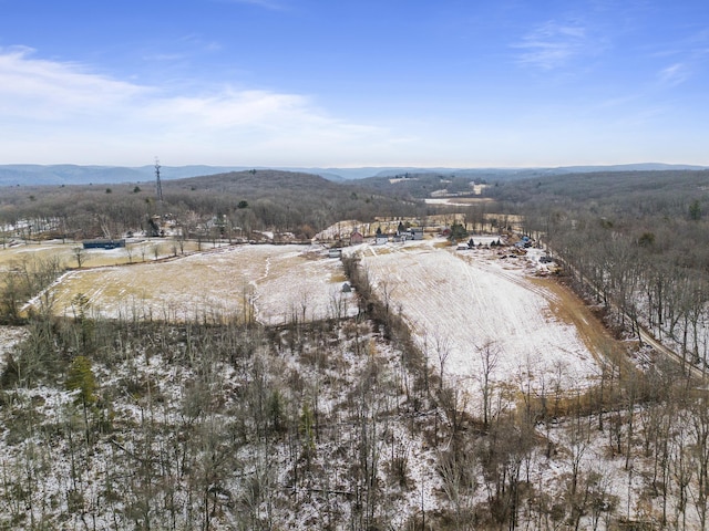 snowy aerial view with a mountain view