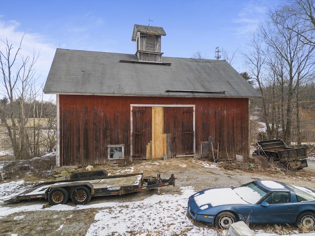 snow covered property with an outdoor structure