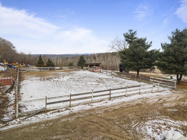 yard covered in snow with a rural view