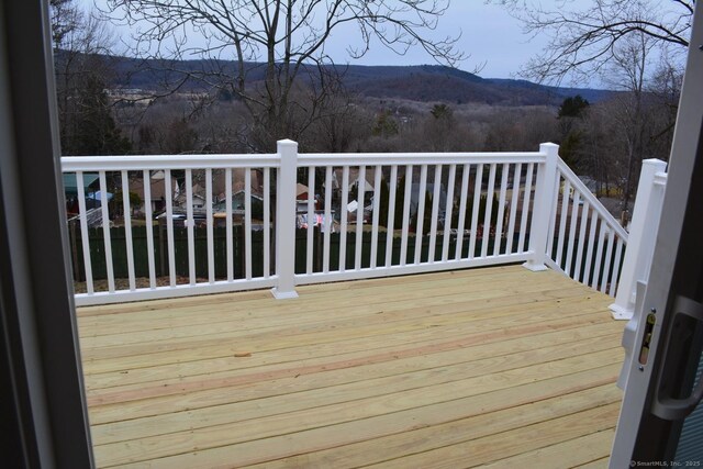 wooden deck with a mountain view