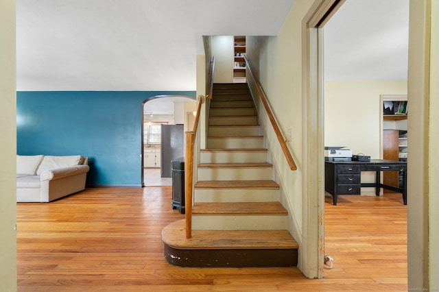 staircase with wood-type flooring