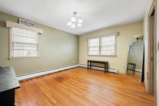 interior space featuring an inviting chandelier, light hardwood / wood-style flooring, and a baseboard radiator