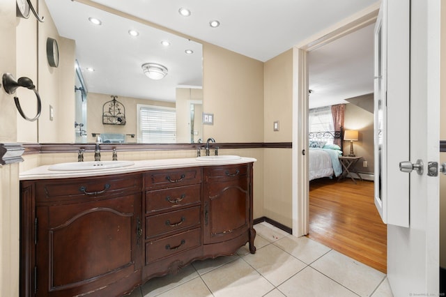 bathroom featuring vanity, a wealth of natural light, tile patterned floors, and a baseboard radiator