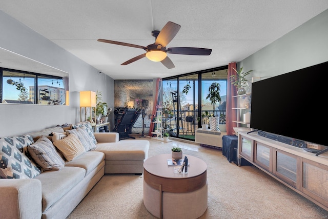 living room with a textured ceiling, ceiling fan, and light carpet