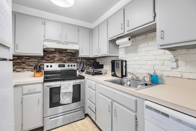 kitchen with backsplash, dishwasher, sink, stainless steel range with electric cooktop, and a textured ceiling