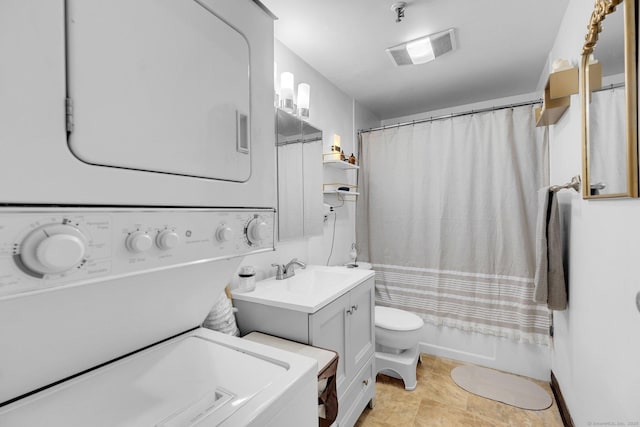 full bathroom featuring stacked washer / dryer, toilet, vanity, and shower / tub combo