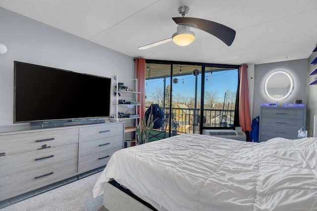 bedroom with ceiling fan, carpet, expansive windows, and access to outside