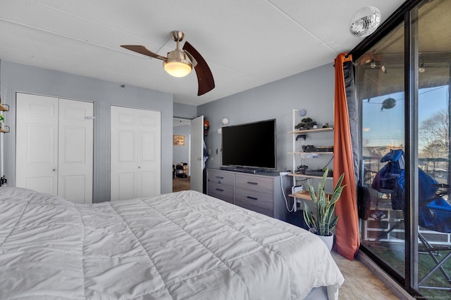 bedroom with ceiling fan, access to exterior, and multiple closets