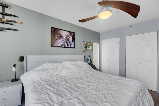 bedroom featuring ceiling fan and multiple closets