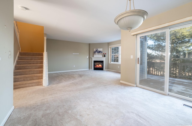 unfurnished living room featuring carpet