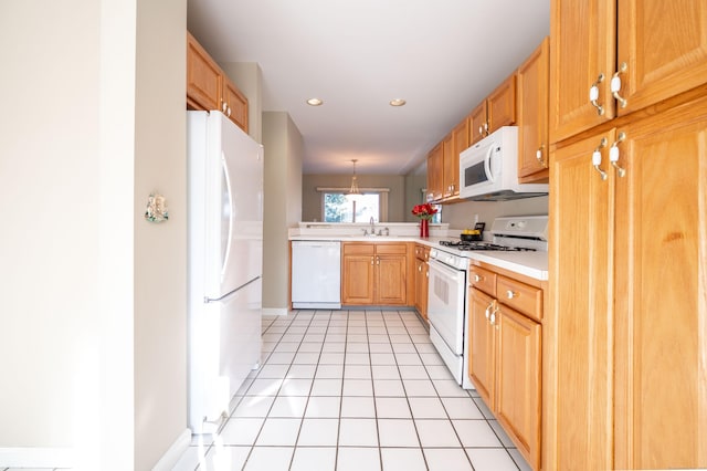 kitchen with sink, hanging light fixtures, white appliances, and light tile patterned floors