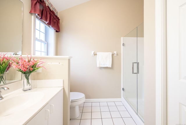 bathroom featuring vanity, a shower with shower door, tile patterned floors, and toilet