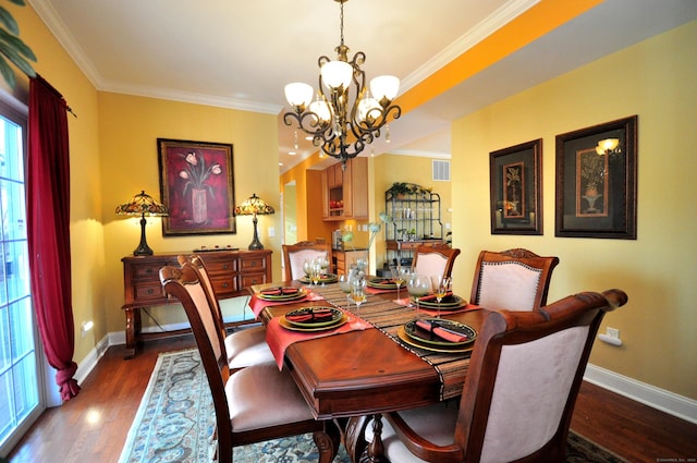 dining space featuring an inviting chandelier, crown molding, and dark hardwood / wood-style floors