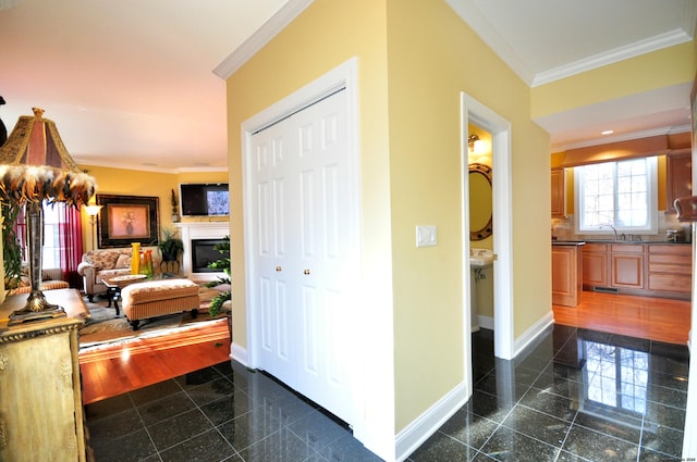 hall featuring sink and ornamental molding