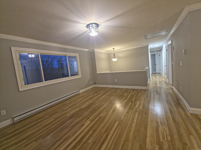 empty room featuring a baseboard radiator, crown molding, baseboards, and wood finished floors