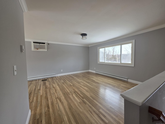 empty room with a baseboard radiator, ornamental molding, wood finished floors, and a wall mounted AC