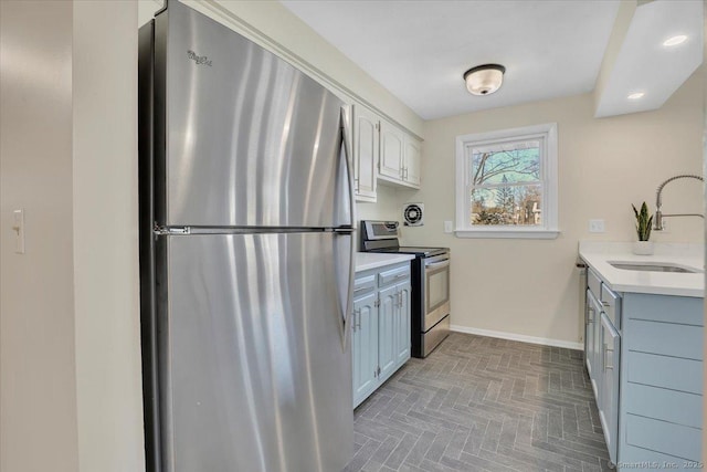 kitchen with white cabinetry, stainless steel appliances, and sink