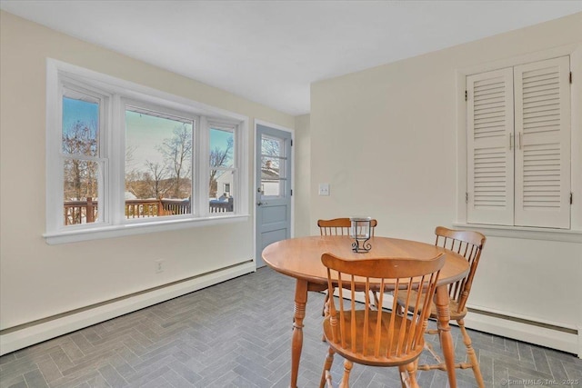 dining space featuring a baseboard heating unit