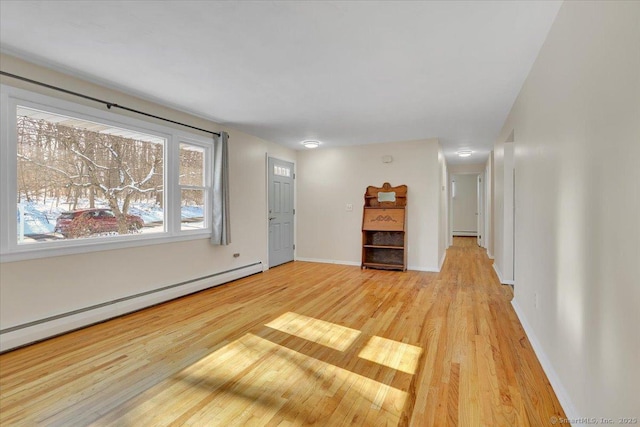 unfurnished living room featuring light hardwood / wood-style flooring and a baseboard radiator