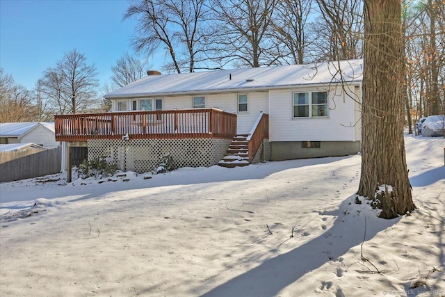 snow covered property with a wooden deck