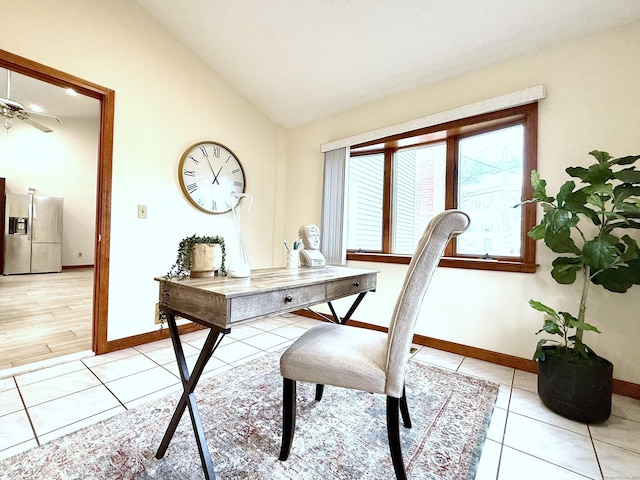 office featuring lofted ceiling, ceiling fan, and light tile patterned flooring