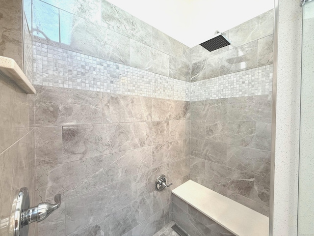 bathroom with a tile shower