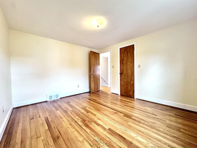 spare room featuring light hardwood / wood-style flooring