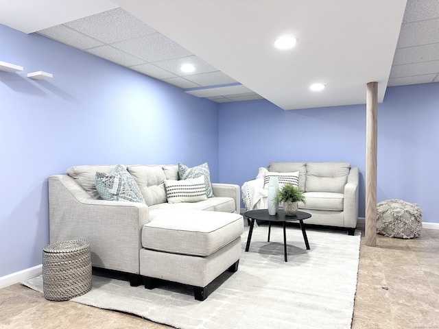 living area with a paneled ceiling