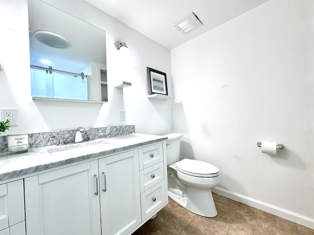 bathroom featuring toilet and vanity