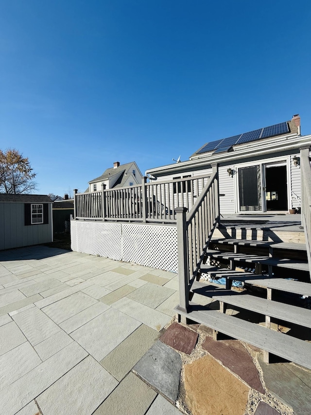 view of patio / terrace featuring a deck and an outbuilding