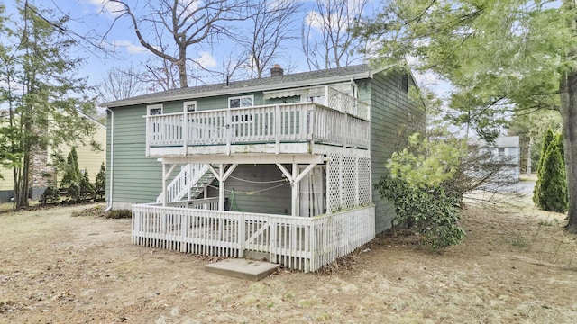 rear view of property with a wooden deck