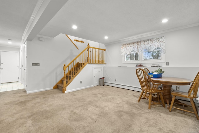 dining room featuring light colored carpet, a baseboard heating unit, and ornamental molding