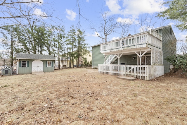 rear view of property with a storage shed and a wooden deck